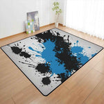 Blue Black Paint Splatter Area Rug - full view in modern room | Our Phoenix Rise