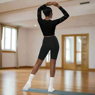 Black Neon Grid Long Sleeve Crop Top - Woman stretching, full back view | Our Phoenix Rise