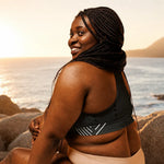 Recycled Longline Sports Bra - Lifestyle View Sitting on Beach | Our Phoenix Rise
