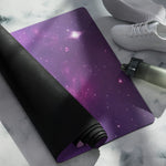 Purple galaxy pattern yoga mat partially rolled showing black underside | Our Phoenix Rise